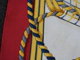 a yellow and blue tie on a red and white cloth