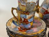 a lot of cups and saucers sitting on a table