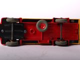 a red and yellow toy train on a white surface