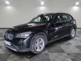 a picture of a black bmw suv parked on a checkered floor