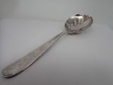 a spoon that is sitting on a white surface