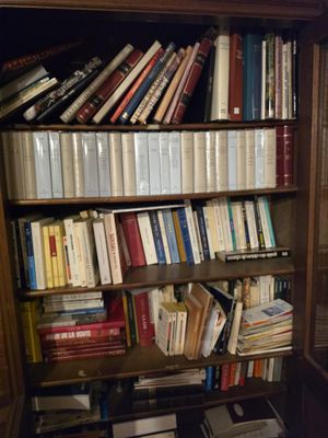 a book shelf with many books on it in a room