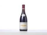 a bottle of red wine sitting on top of a table