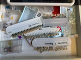 a drawer full of sewing supplies on a table