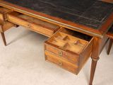 a desk with drawers and a chalk board on it