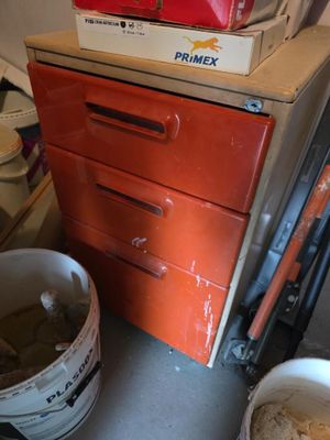 a stack of boxes on top of a dresser in a room
