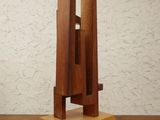 a wooden sculpture that is on a wooden table