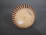 an old baseball that is sitting on top of a table