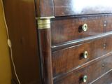 a brown dresser with a marble top in a room