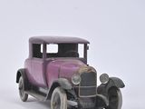 a toy car that is sitting on a white surface