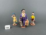 three figurines of people with luggage and luggage bags