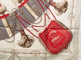 a red and white scarf with a picture of a horse on it