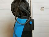an image of a blue and black pressurer in a garage