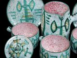 a group of cups and saucers with designs on them
