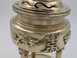 an antique brass dog figurine on top of a pedestal