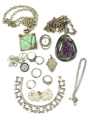 a lot of jewelry that is laying out on the table