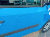 a small blue car with a sticker on the side of it