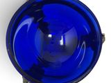 a blue glass bowl sitting on top of a white table