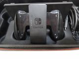 two nintendo switch controllers in a case with a charger