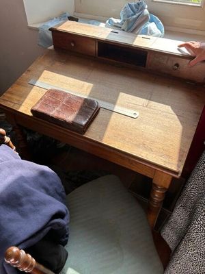 a woman standing in front of a desk with a mirror