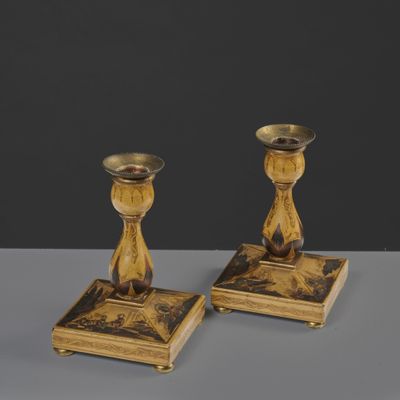 pair of antique brass candlesticks with black and gold designs
