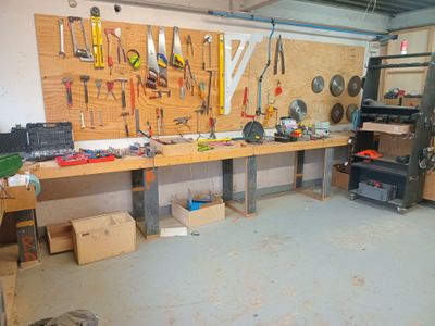 a workbench with tools on it in a garage
