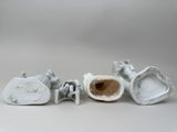 three pieces of porcelain on a white surface
