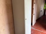 a refrigerator in the corner of a room with a brick floor