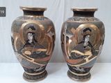 two vases that are sitting side by side on a table