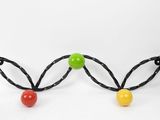 a close up of a pair of beads on a white surface