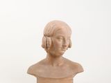 bust of a woman in profile with hair in a bun