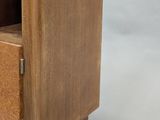 a small wooden cabinet with a marble top