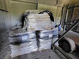 a large pile of boxes and bags in a warehouse