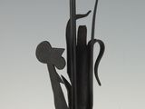 statue of a bird in a vase on a pole with a sky background