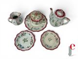 a tea pot, cup, saucer, and saucer on a white background