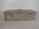 an old metal box with a handle on a table
