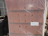 a pile of mattresses sitting on a pallet next to a brick wall