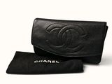a black chanel wallet with a black case and a black bag