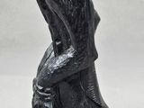 a black statue of a man with a hat on his head