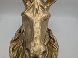 brass horse head with long mane on a white background
