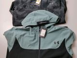 a couple of jackets sitting next to each other on top of a table