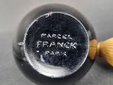 a close up of a metal object with a wooden handle