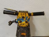 a close up of a yellow and black machine on a table
