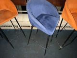 three orange and blue chairs sitting next to each other