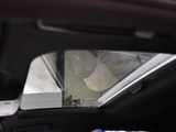 a picture of a view of a building through the rear window of a car