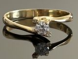 a gold ring with a diamond on top of it