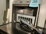a silver oven with a black counter top and a blue sign on the door