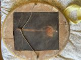 a picture of a piece of wood on a table next to a cup