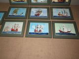 six framed pictures of ships on display on the floor