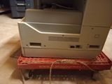 a printer sitting on top of a cart in a room